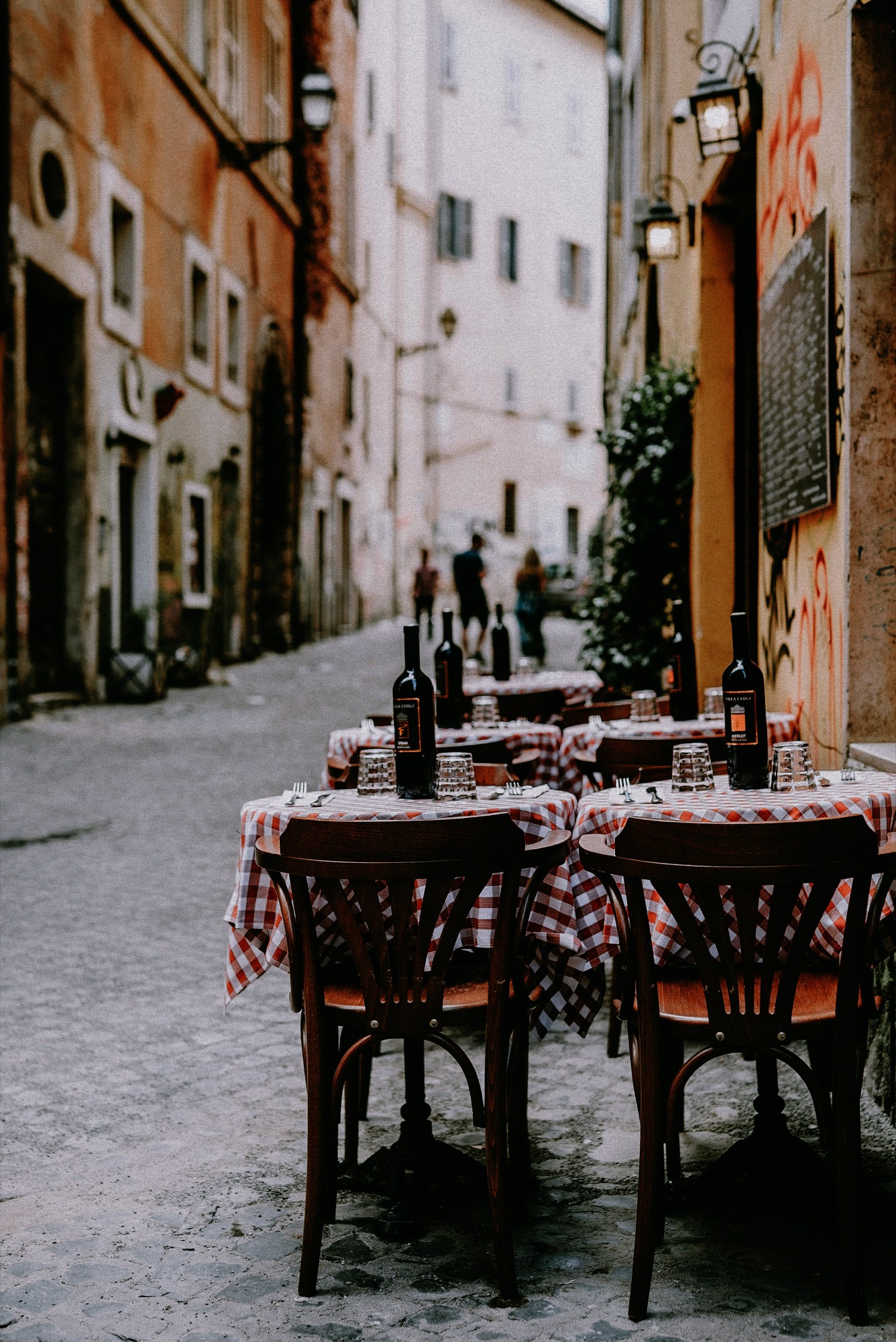 Evening trattoria tables on an Italian street